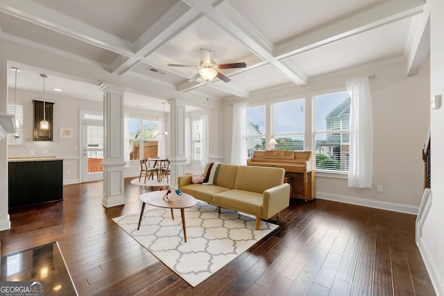 living room featuring beamed ceiling, ornate columns, and coffered ceiling