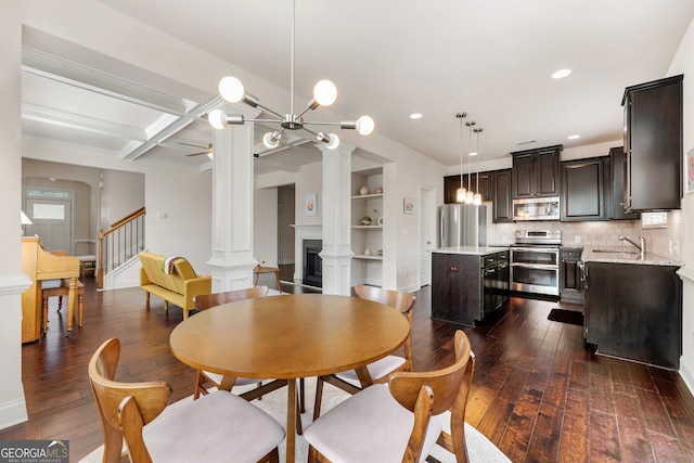 dining room with beamed ceiling, built in shelves, dark hardwood / wood-style flooring, and coffered ceiling