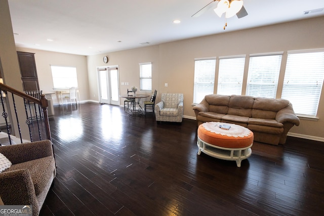 living room featuring ceiling fan, dark hardwood / wood-style flooring, and a wealth of natural light