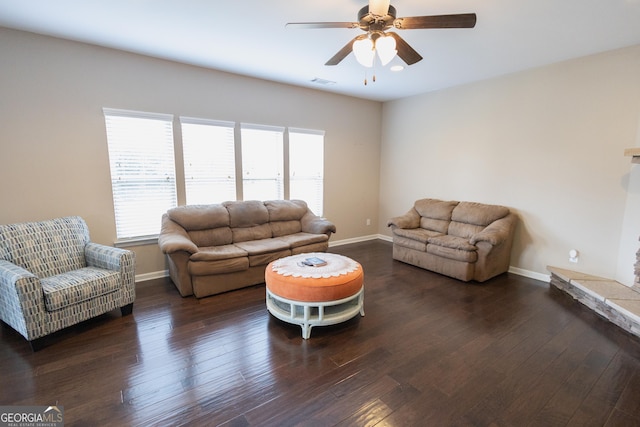 living room with ceiling fan, dark wood-type flooring, and a fireplace