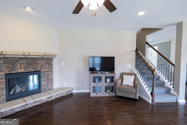 unfurnished living room with ceiling fan, dark hardwood / wood-style flooring, and a fireplace