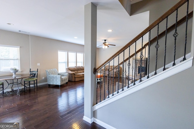 staircase featuring hardwood / wood-style flooring and ceiling fan