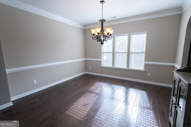 unfurnished dining area featuring ornamental molding, dark wood-type flooring, and an inviting chandelier