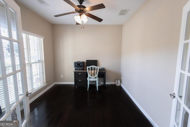 unfurnished office with french doors, ceiling fan, and dark hardwood / wood-style floors