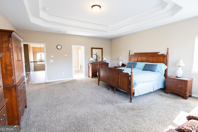 bedroom featuring a tray ceiling and light colored carpet