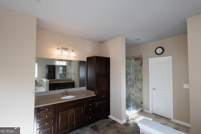 bathroom featuring an enclosed shower and vanity