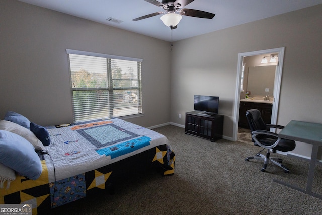 bedroom with ceiling fan, carpet flooring, and connected bathroom