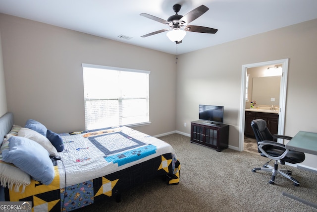 bedroom with ensuite bathroom, carpet floors, ceiling fan, and sink