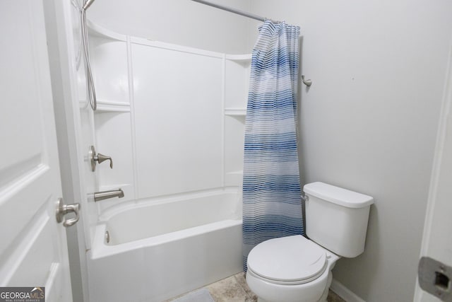 bathroom with toilet and shower / bath combo with shower curtain