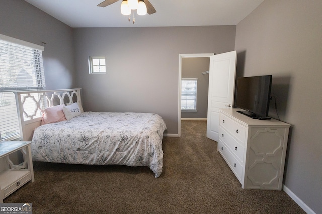 bedroom with ceiling fan and dark carpet