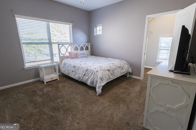 bedroom with dark colored carpet