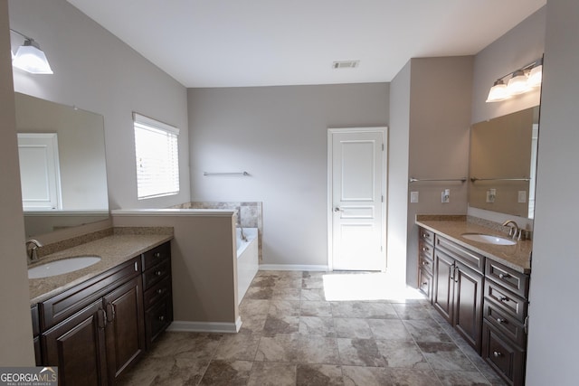 bathroom with a bath and vanity