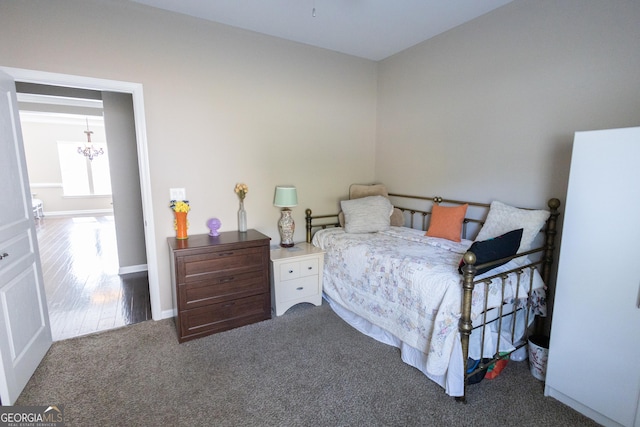 bedroom with carpet and a chandelier