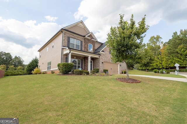 view of front of home with a front yard and a garage