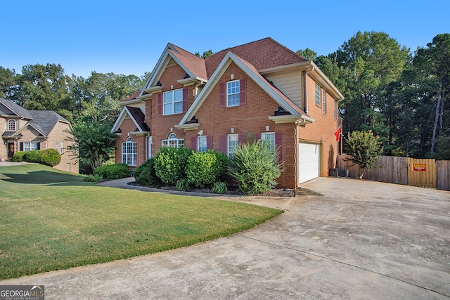 view of front of property with a garage and a front yard