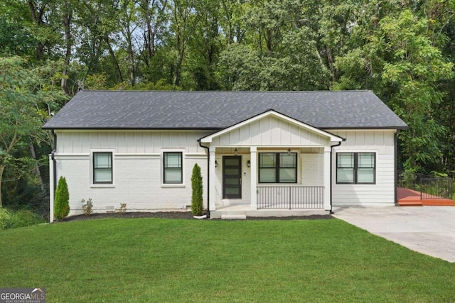 ranch-style house with a front lawn and covered porch