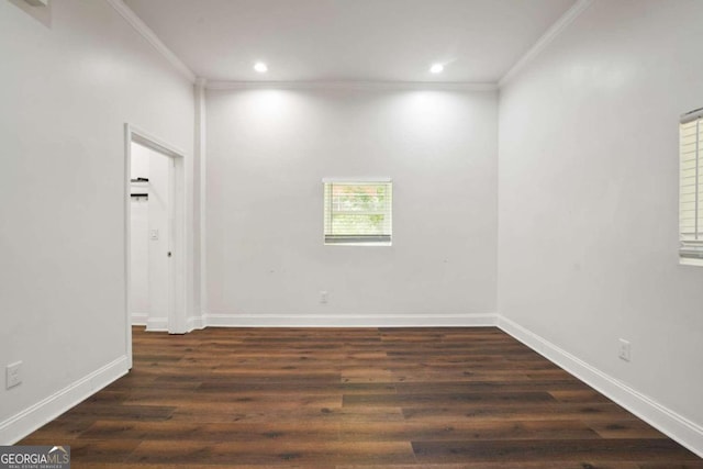 spare room with crown molding and dark hardwood / wood-style flooring