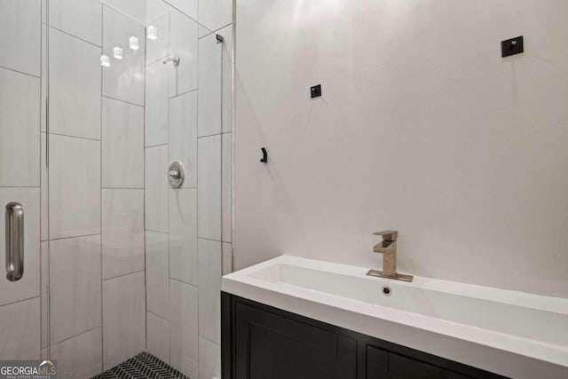 bathroom featuring vanity and a shower with door