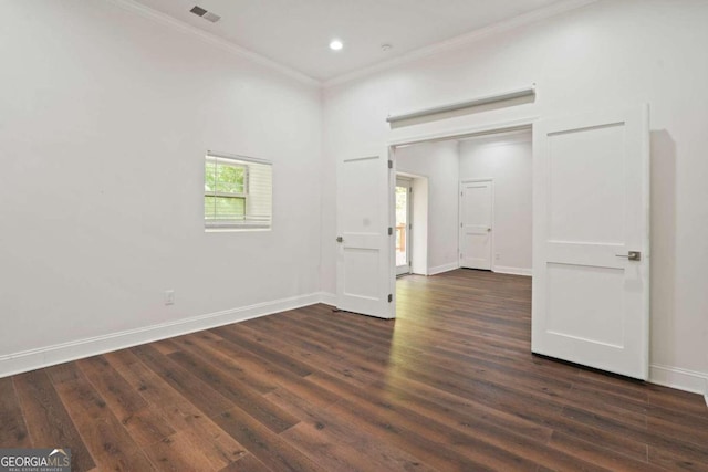 unfurnished room with ornamental molding and dark wood-type flooring