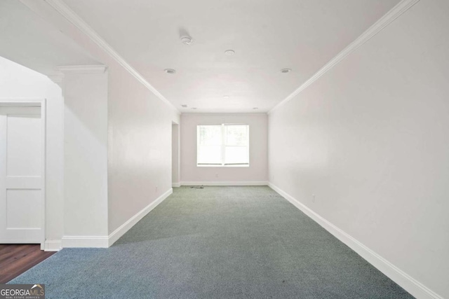 carpeted empty room featuring crown molding