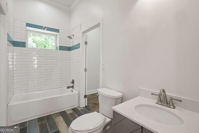 full bathroom featuring wood-type flooring, tiled shower / bath, vanity, and toilet