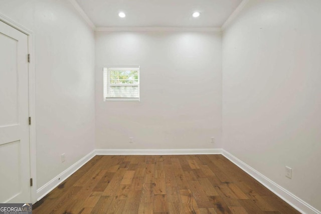 unfurnished room with crown molding and dark hardwood / wood-style flooring