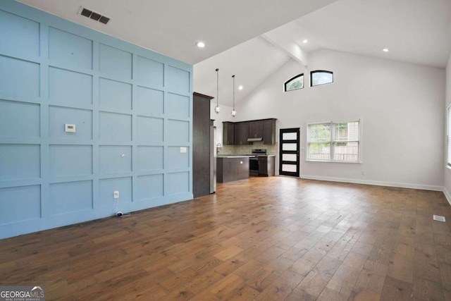 unfurnished living room with high vaulted ceiling, beamed ceiling, and dark hardwood / wood-style flooring