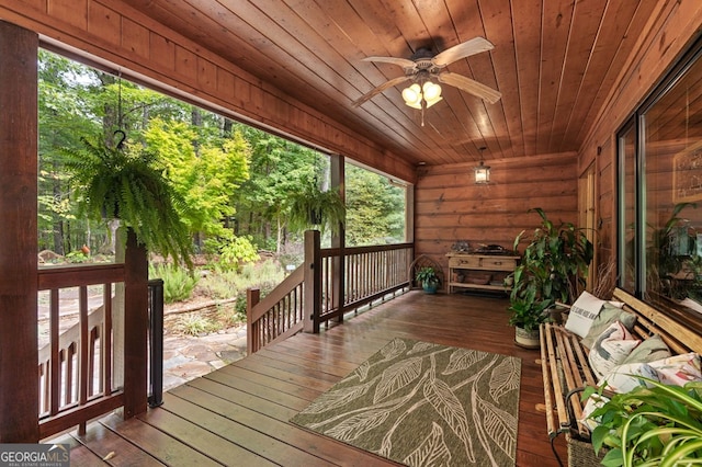 unfurnished sunroom with wood ceiling, ceiling fan, and plenty of natural light