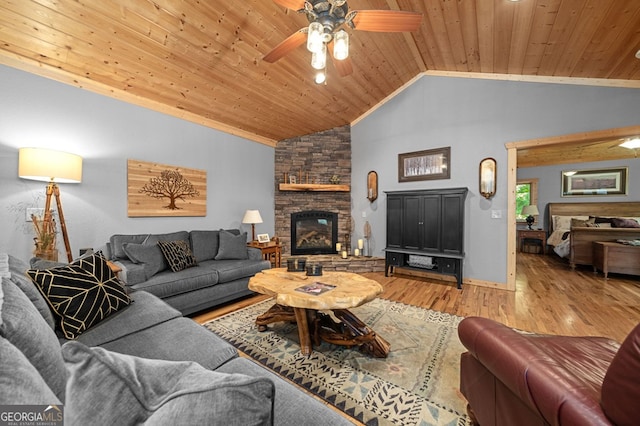 living room with wood ceiling, vaulted ceiling, a fireplace, hardwood / wood-style floors, and ceiling fan