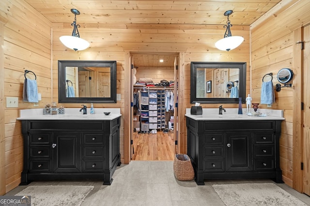 bathroom with wood-type flooring, vanity, wood walls, and wooden ceiling