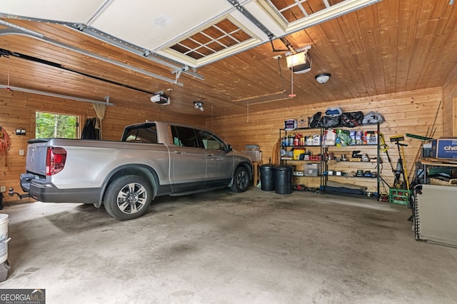 garage with a garage door opener and wood walls