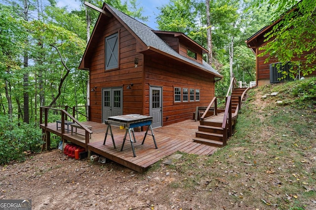 rear view of house featuring a deck