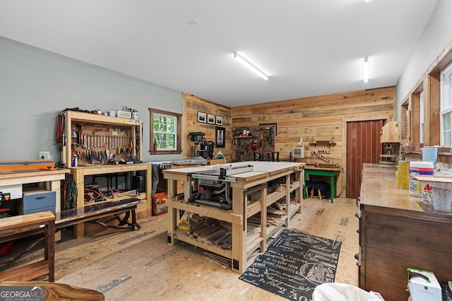 interior space featuring light wood-type flooring, a workshop area, and wood walls