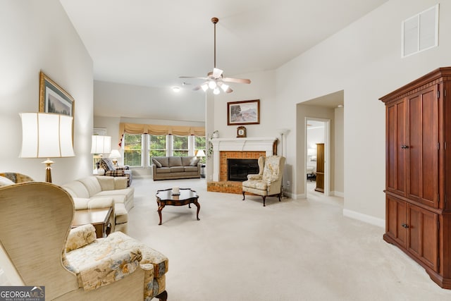 living room featuring light carpet, ceiling fan, and a brick fireplace