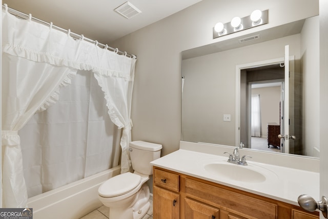 full bathroom featuring vanity, shower / bath combo with shower curtain, toilet, and tile patterned flooring