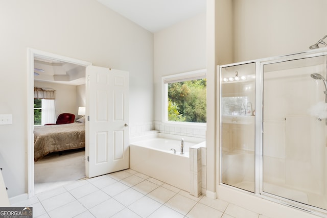 bathroom with separate shower and tub and tile patterned flooring