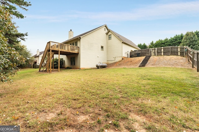 rear view of property with a deck and a lawn