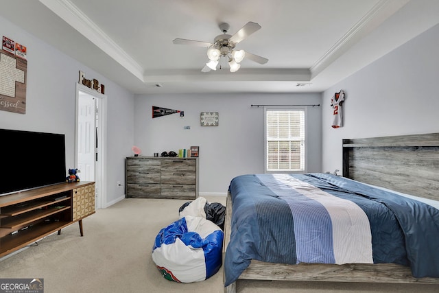 bedroom with ceiling fan, a tray ceiling, and crown molding