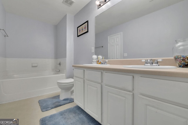 bathroom with toilet, vanity, and a bathing tub