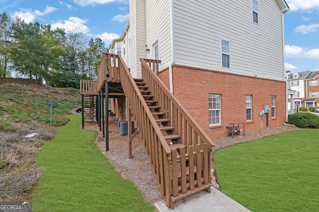 exterior space featuring a yard and central AC