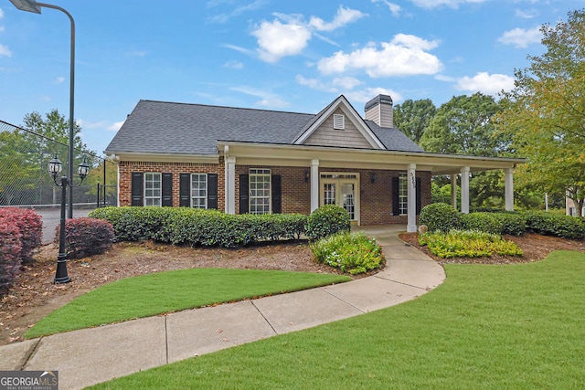 view of front of property with covered porch and a front yard