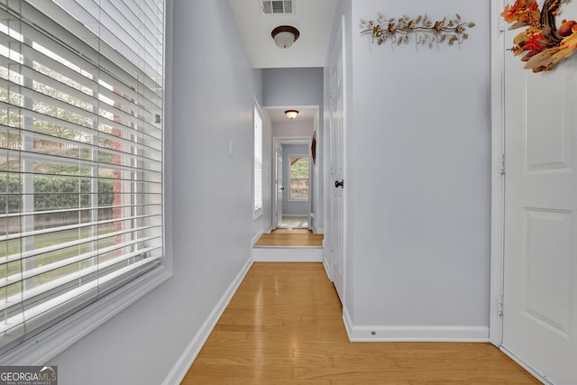 hallway with light hardwood / wood-style floors