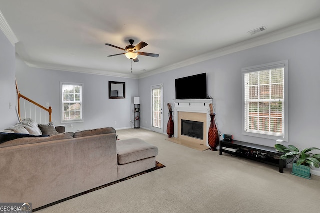 carpeted living room featuring a wealth of natural light, ceiling fan, and crown molding