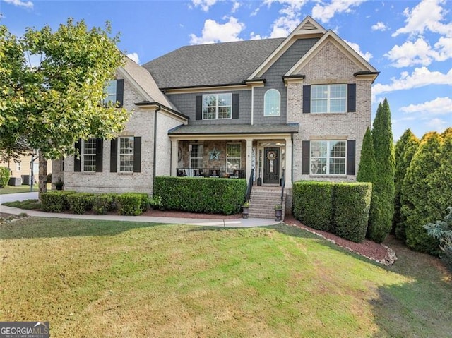 view of front of home featuring a front lawn and covered porch