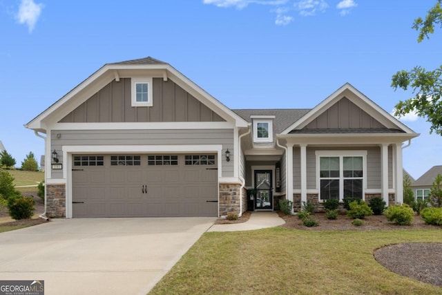 craftsman inspired home featuring a garage and a front lawn