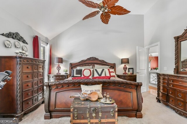 carpeted bedroom with high vaulted ceiling and ceiling fan