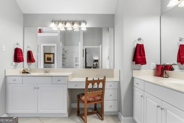 bathroom featuring tile patterned flooring, vanity, and tiled shower