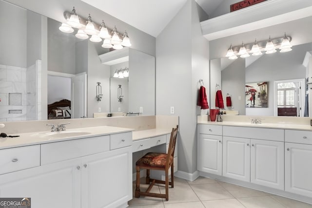 bathroom with vanity, lofted ceiling, and tile patterned flooring