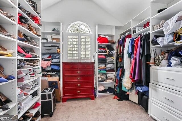 spacious closet featuring light carpet and lofted ceiling