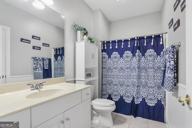 bathroom featuring vanity, tile patterned flooring, and toilet